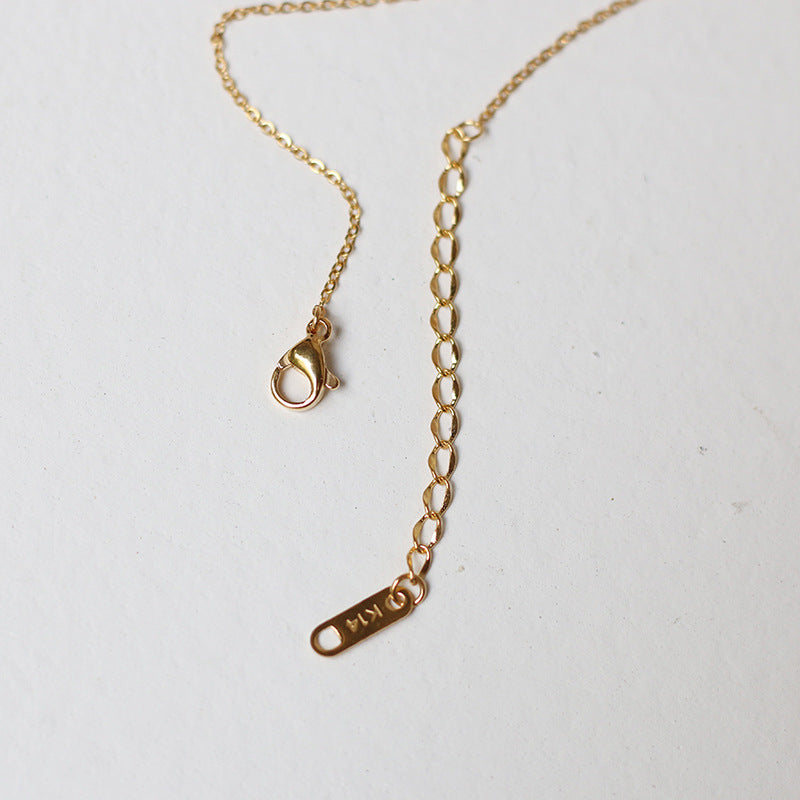Nelly – Minimalistische Kreuzkette in Gold